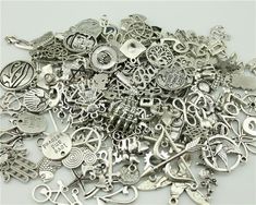 a pile of silver colored metal charms