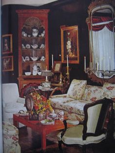 a living room filled with furniture and pictures on the wall