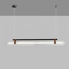 three lights hanging from the ceiling in a room with grey walls and white flooring