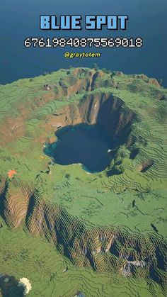 an aerial view of a blue spot in the middle of some green hills and water