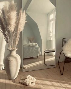 a large mirror sitting on top of a wooden floor