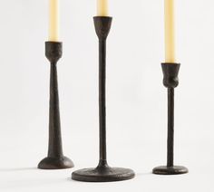 three candles are standing next to each other