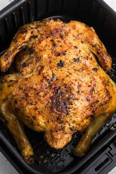 a roasting pan with a whole chicken in it