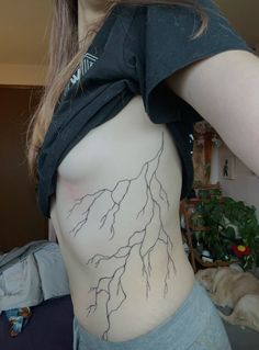 a woman's back with lightning drawn on it and the bottom part of her stomach