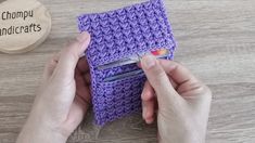 someone is crocheting a small purple case with scissors in it on a table