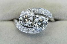 an engagement ring with two round brilliant cut diamonds