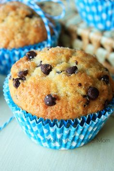 chocolate chip muffins in blue wrappers on a table