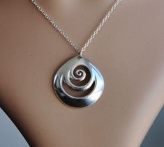 Hand crafted New Zealand Maori koru design in Solid 925 Sterling silver. A Sculptural piece that is fully shaped on both sides and has a presence around your neck. Finished to a high polish. This domed piece really stands out & captures the light. The Maori koru design is a treasured symbol in New Zealand.. it is found in nature in the fern fronds of the forest, symbolising new beginnings & spiritual growth bringing renewal & inspiring new ideas & adventures. As a symbol for new Spiral Shaped Sterling Silver Jewelry, Silver Spiral Necklace For Anniversary, Spiral Sterling Silver Necklace In Silver, Maori Koru, Metal Art Jewelry, Silversmithing Jewelry, Diy Jewelry Pendants, Silver Ring Designs, Silver Rings With Stones