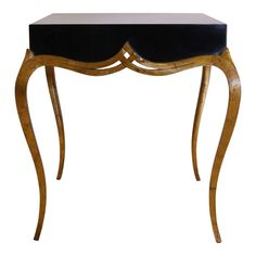 an ornate wooden table with black velvet top