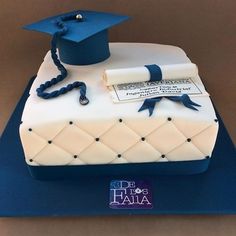 a cake with a graduation cap and diploma on it