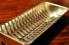 a close up of a metal tray on a wooden table