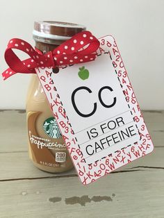 a jar of coffee with a red bow on it and a sign that says cc is for cafine