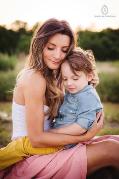 a woman holding a small child in her arms