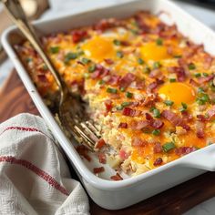 a casserole dish with eggs and bacon in it