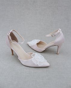 Classic satin pointy toe heels adorned with large white pearl primrose flower applique. Sleek and glamour is a great combination and will definitely be a favorite. DETAILS: HEELS: 3 inches COLORS AVAILABLE: Dusty Pink, Light Blue, Black, Champagne, Ivory, and White UPPER: Synthetic upper and lining MATERIALS: Manmade outsole ORIGIN: Imported STYLE NAME: BELL