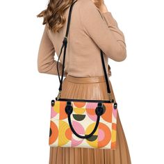 • Elevate your style with our retro style 60s Space Age Opt Art Handbag, a chic fusion of mod and vintage aesthetics inspired by the iconic designs of the 60s.• This Mod 60s Handbag features a mesmerizing geometric opt art pattern print in vibrant shades of orange, pink, yellow, and black, adding a bold and artistic touch to any outfit.• Crafted from premium PU leather, this Retro Handbag Women boasts an exquisite zipper closure and comes with a removable strap for added versatility.• Available in three sizes - small, medium, and large - and with two handle options in black and white, this 60s Style Handbag offers both style and practicality for every occasion.**Designed in California by Trendy Hip Buys. Made to order from overseas. Vintage Satchel With Detachable Strap For On-the-go, Vintage Rectangular Satchel For On-the-go, Retro Rectangular Box Bag For Everyday Use, Retro Box Shoulder Bag With Removable Pouch, Retro Shoulder Box Bag With Removable Pouch, Retro Crossbody Box Bag For Travel, Retro Travel Crossbody Box Bag, Retro Box Bag With Removable Pouch, Retro Travel Box Bag With Removable Pouch