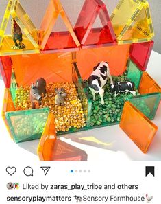 an assortment of small plastic animals and other items in containers on a table with text that reads, i liked by zaras - play tribe and others sensorymatters