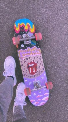 a person standing next to a skateboard on the ground