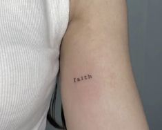 a woman's arm with the word faith tattooed on it