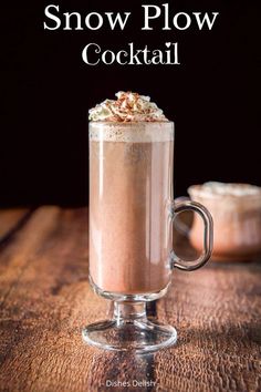 a glass mug filled with hot chocolate and topped with whipped cream