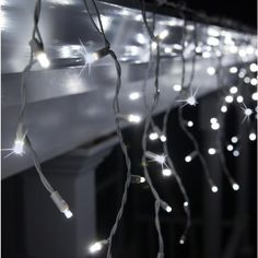 some lights are hanging from the side of a building