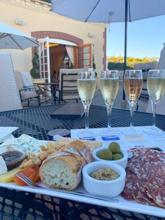 some glasses of wine and food on a table