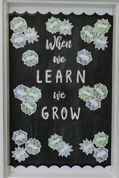 a chalkboard with the words when we learn we grow written on it