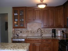 a kitchen with wooden cabinets and granite counter tops