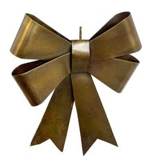 a brass bow ornament on a white background