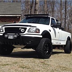 a white truck parked in front of a house