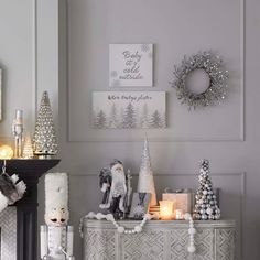 a living room decorated for christmas with white and silver decorations