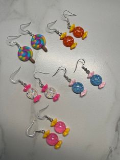 some candy earrings are sitting on a table