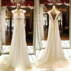 wedding dress on mannequins in front of mirror