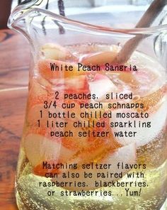 a pitcher filled with ice and fruit on top of a table