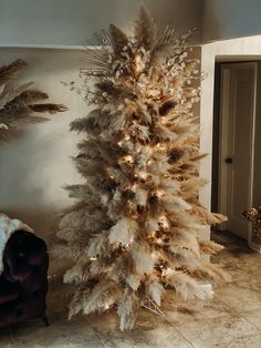 a white christmas tree in the corner of a room