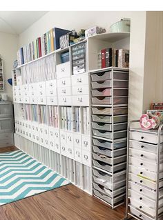 a room filled with lots of white drawers and filing cabinets next to a blue rug