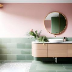 a bathroom with pink walls and green tiles