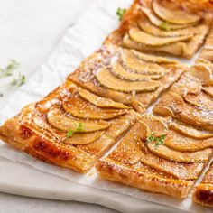 slices of apple tart sitting on top of white paper