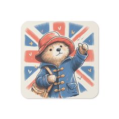 a square coaster with an image of a teddy bear wearing a red hat and blue coat