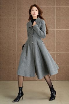 Elevate your winter wardrobe with this classic gray wool coat. Designed with a fitted bodice and a flared A-line skirt, this coat offers a flattering silhouette that exudes elegance.This coat is a must-have for your seasonal collection. DETAIL * 50% wool blend, 50% fiber,nylon * Polyester lining * Long sleeve wool coat * Single breasted buttons * Two seam Pockets * Below the Knee Length * Fit and flare coat, dress coat * Perfect for winter, autumn * Dry clean MODEL SIZE Bust 85 cm(33.4") Waist 67 cm(26.7") Height 168cm (5' 6") She wears size XS Choose CUSTOM Order if you * Need a better fit * Can't find your size in our size Chart * Change the Style * Chang the Length * Your Height is not Between 5'1" - 5"9" * Your weight is over 75 kg SIZE GUIDE Size vary between Brand and Country Please Elegant Gray Sweater Coat For Fall, Gray Single-breasted Wool Coat For Fall, Gray Single Breasted Long Wool Coat, Gray Single-breasted Long Wool Coat, Elegant Gray Wool Coat With Buttons, Elegant Long Gray Wool Coat, Grey Wool Coat, Fit And Flare Coat, Gray Wool Coat