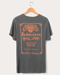 There's nothing better than a fresh Budweiser. That goes for a fresh Budweiser tee too! Made with their signature 100% mid-weight loose knit cotton for that relaxed fit. Featuring a Budweiser text graphic on the front of the tee, and a large Budweiser graphic on the back of the tee. Hurry up and grab yours while you still can. Men’s vintage tee Signature loose knit / mid-weight 100% cotton jersey Distress & grinding at neck, sleeve and hem 1x1 rib neck band Ladder stitching at sleeve and body he Womens Vintage Tees, Beer Collection, Text Graphic, Food Clothes, Hat Print, Logo Vintage, Loose Knit, Classic Logo, Vintage Tee