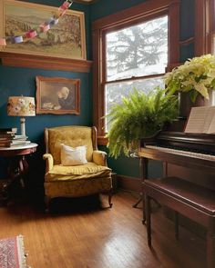 a living room filled with furniture and a piano in front of a painting on the wall