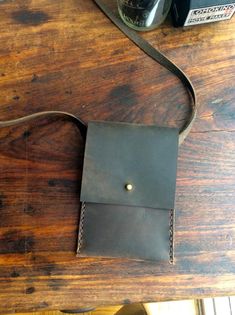 a brown leather case sitting on top of a wooden table