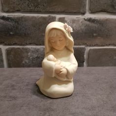 A beautiful vintage bisque figurine of a kneeling Mother Mary holding the baby Jesus by Homco 1992.  Pastel colored Nativity figurine of Mary and Jesus. Measures: 4 1/4'' height x 2'' x 2 1/2''. Weight: 5.3 oz. Vintage figurine is in good pre-owned condition with no chips or cracks. Mary And Jesus, Baby Jesus, Mother Mary, Collectible Figurines, Nativity, Figurines, Chips, Jesus, Pastel