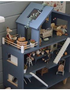 a toy doll house with furniture and accessories