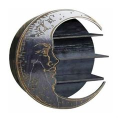 a clock with the face of a man on it's side and a crescent