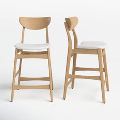 two wooden chairs sitting side by side on a white surface with one chair up against the other