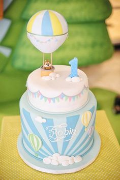 a blue and white cake with a hot air balloon on top