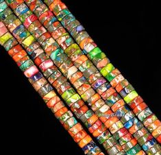 multicolored glass beads are stacked on top of each other