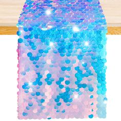 a blue and pink sequinized table runner